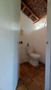 a bathroom with a toilet in a room at Cabañas Coloniales con Entorno Natural en Barichara in Barichara