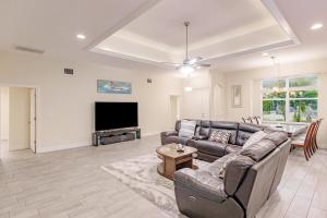 a living room with a couch and a flat screen tv at Casa Bonita in Bonita Springs