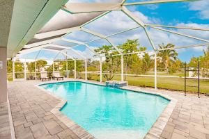 an indoor swimming pool with a glass canopy over it at Casa Bonita in Bonita Springs