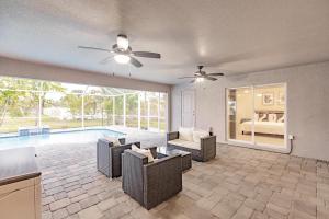 a living room with a couch and chairs and a pool at Casa Bonita in Bonita Springs