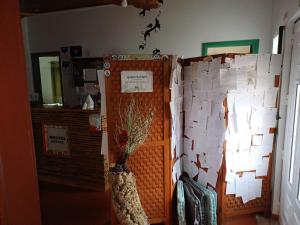a room with a wall covered in papers at Hostel Nature in Zambujeira do Mar