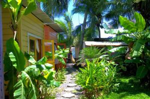 a garden with a walkway next to a house at Boathouse Bungalows By The Sea in Bocas Town
