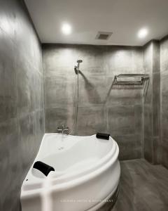 a bathroom with a white sink and a shower at caldera hotel in Kintamani