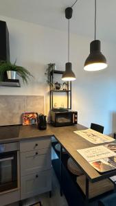 a kitchen with a counter top with two pendant lights at BELLAVISTA-lake view apartment in Ranco