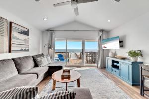 a living room with a couch and a table at Flip Flops & Sun in Gulf Shores