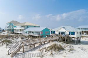 a group of houses on the beach with sandici at Flip Flops & Sun in Gulf Shores
