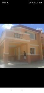 a large yellow house with a parking meter in front of it at Noana Crib in Davao City