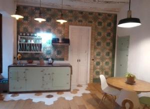 a kitchen with a table and a dining room at La gota de leche 1 in Sanlúcar de Barrameda