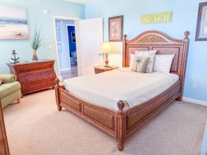 a bedroom with a bed and a dresser and a chair at Aqua Beach Hotel in Wildwood Crest