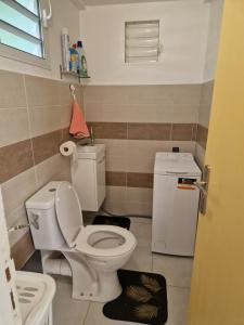uma pequena casa de banho com WC e lavatório em An'Kanna em Petit-Bourg