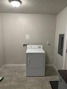 a laundry room with a small white appliance in it at The Cottage House in Hampton