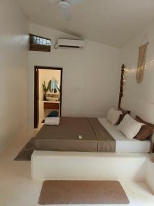 a bedroom with a large bed in a room at Rooms in Greek Jungle Villa, Thalassa Road in Siolim