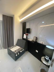 a room with a bed and a table and a chair at Villa Jelena in Negotino