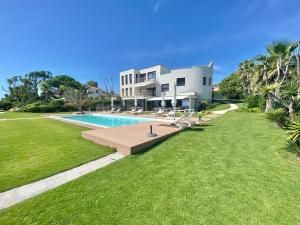 a large house with a swimming pool and a yard at Fenandgi Luxury Hospitality at its finest ! in Porto Columbu - Perdʼe Sali