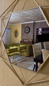 a mirror reflection of a living room with a clock at P&l exclusive beauty parlour in Johannesburg