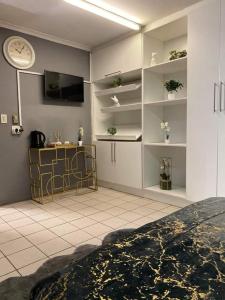 sala de estar con reloj en la pared en P&l exclusive beauty parlour, en Johannesburgo