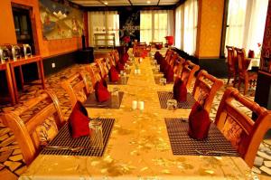 a long table with chairs and red napkins on it at Himalayan Star Resort in Paro