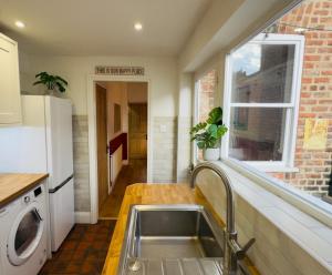 a kitchen with a sink and a window at Great Town House - Central York in York