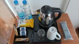 a table with a coffee maker and bottles of water at Himalayan Star Resort in Paro