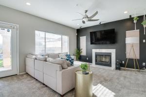 a living room with a couch and a fireplace at Spacious Scottsdale Home with Private Heated Pool in Scottsdale