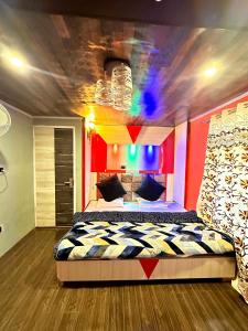 a bedroom with a large bed in a room with colorful walls at Eco Rooms in Jawāharnagar
