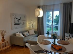 a living room with a couch and a table at Apartment Solare in Portorož