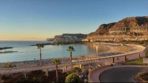 a beach with a bunch of people on the beach at Casa Reina Tauro with private pool in La Playa de Tauro