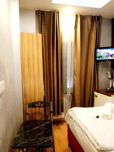 a room with a bed and a chair and a television at Family Hotel Taksim in Istanbul