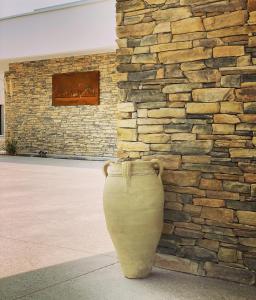 a large vase sitting in front of a stone wall at Villa Saint Andrews in Marly +6 photos