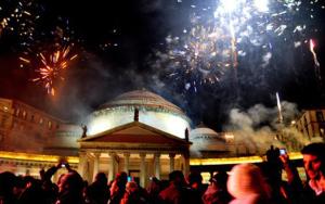 a crowd of people standing in front of a building with fireworks at Naples Luxury Suites B&B in Naples