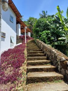 a set of stone stairs next to a house at Flat com vista Espetacular in Angra dos Reis