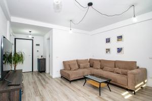 a living room with a couch and a table at Studio modern in Craiova