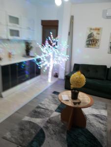 a living room with a christmas tree with lights at Apartman Old Town in Stolac
