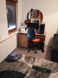 an office with a desk with a chair and a mirror at Apartman Old Town in Stolac