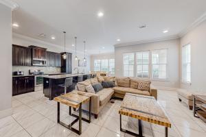 a living room with a couch and a kitchen at Miramar Beach Villas #946B in Destin