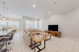 a living room with a couch and a tv at Miramar Beach Villas #946B in Destin