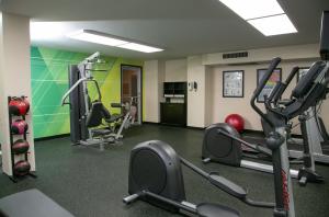 a gym with treadmills and machines in a room at Holiday Inn Metairie New Orleans, an IHG Hotel in Metairie