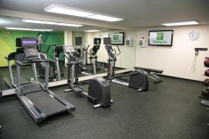 a gym with several tread machines in a room at Holiday Inn Metairie New Orleans, an IHG Hotel in Metairie