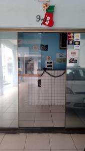 a glass door of a store with a car in it at Hotel Vila de São Vicente in São Vicente