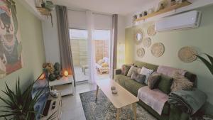 a living room with a green couch and a table at STAY Green Apartment in Larnaca
