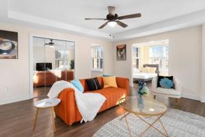 a living room with an orange couch and a table at Affordable 1-BR by DMC Detroit in Detroit