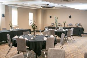 a conference room with tables and chairs and tablesktop at Holiday Inn Metairie New Orleans by IHG in Metairie +37 photos