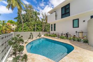 a swimming pool in the backyard of a house at Casa Loba Luxe Apartment with pool and ocean views in Rincon