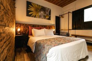 a bedroom with a bed and a painting on the wall at Hotel Termales del Ruiz in Manizales +73 photos