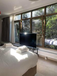 Tsakalof 10 View Central Apartment by SuperHost Hub في أثينا: غرفة نوم بسرير كبير ونافذة كبيرة