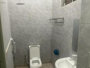 a bathroom with a toilet and a sink at The First Royal Tour Lodge in Dodoma