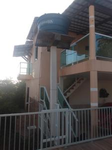 a building with a balcony and stairs on it at Casa de Dona Aida in Itaparica