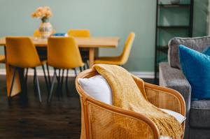 a dining room with chairs and a table with a blanket at NEW Shoreline 401 2BR Condo Near Downtown and Bay in Traverse City