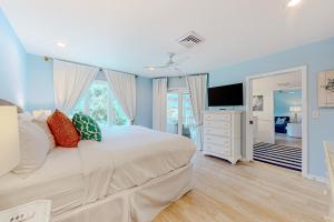 a bedroom with a large bed and a television at Port O' Call G-303 in Isle of Palms