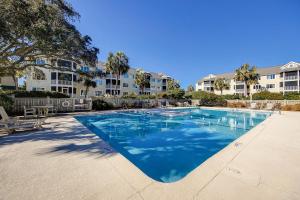 a large swimming pool in a apartment complex at Port O' Call G-303 in Isle of Palms